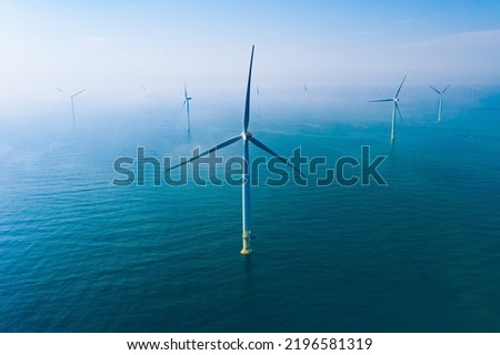 Wind turbine. Aerial view of wind turbines or windmills farm field in blue sea in Finland. Sustainable green clean energy. Royalty-Free Stock Photo #2196581319