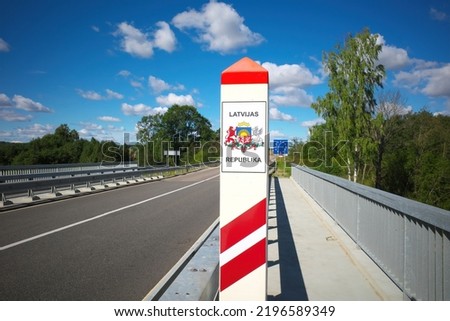 Border post on the border of Latvia. Inscription: Republic of Latvia. Selective focus. Royalty-Free Stock Photo #2196589349