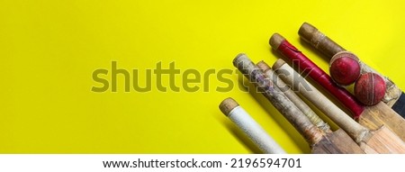 Brown wooden cricket handles which are bound by cotton yarn and artificial leather on yellow background