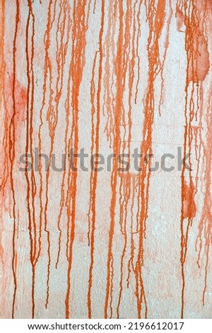 Texture of down flows of orange paint dripping down the wall. Creative background, abstract design element, copy space Royalty-Free Stock Photo #2196612017