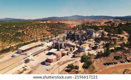 Greek factory or a part of open pit mine seen from drone perspective. Beautiful weather. Air pollution concept. High quality photo