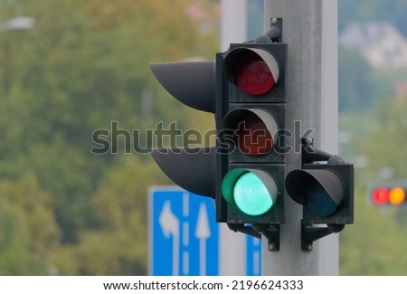Selective focus shot of a green traffic light on a metal pole Royalty-Free Stock Photo #2196624333