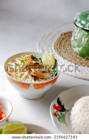 Indonesian Food Soto Ayam or Yellow Chicken Soup Served on the White Table Royalty-Free Stock Photo #2196627141