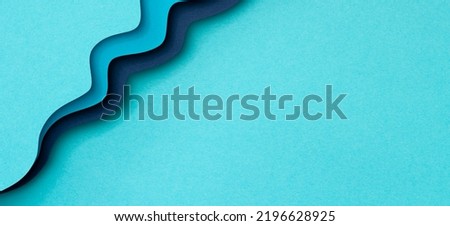 Abstract color papers geometry flat lay paper cut style composition background with blue color lines and shapes. Top view, copy space