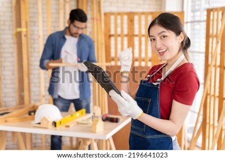 Bright and cheerful Asian female carpenter I'm designing furniture to decorate my own home professionally