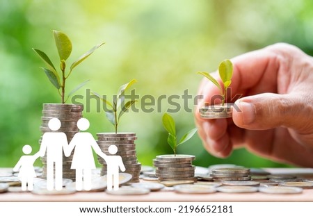 Hand putting coin with plant on coin stack growing and Family icon over green bokeh background,investment and Save Money concept.tree growing on coin,Business Finance, Earning ,Benefit,Capital  