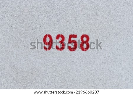 Red Number 9358 on the white wall. Spray paint.
