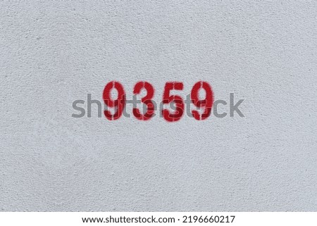 Red Number 9359 on the white wall. Spray paint.
