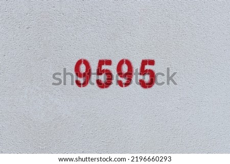 Red Number 9595 on the white wall. Spray paint.
