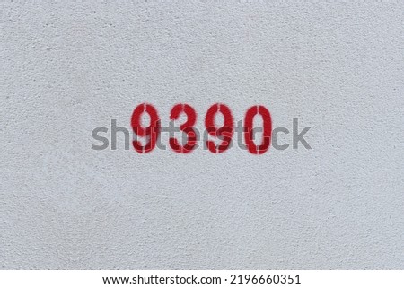 Red Number 9390 on the white wall. Spray paint.
