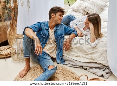 Young attractive couple in love, a man and a woman in cozy boho space    Royalty-Free Stock Photo #2196667131