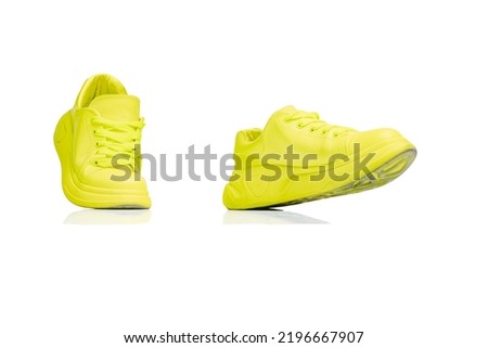 Stylish, trendy, colorful yellow gumshoes, sneakers isolated on white studio background. Comfortable footwear. Concept of fashion, comfort, style, shopping, casual. Copy space for ad, text and Royalty-Free Stock Photo #2196667907