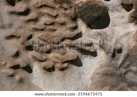 Close up of pattern in heavily eroded stonework of tombstone in cemetery in central Edinburgh, Scotland