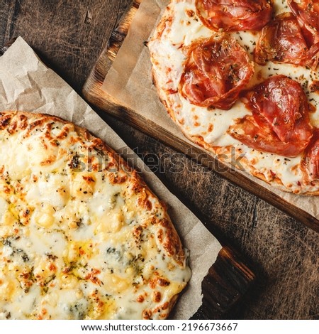 Two Roman-style pizzas with cheese and jamon serrano. Roman square pizza or Pinsa on thick dough, Italian cuisine.