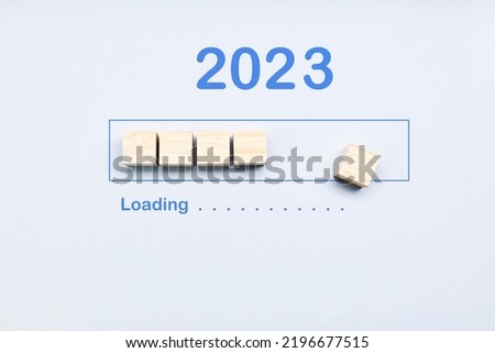 Loading 2023 year on cubes on a blue background. New Year concept. Start concept