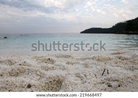 Saliara Beach (called Marble Beach), beautiful white beach in Thassos island, Greece. Landscape with water and rocks at sunset