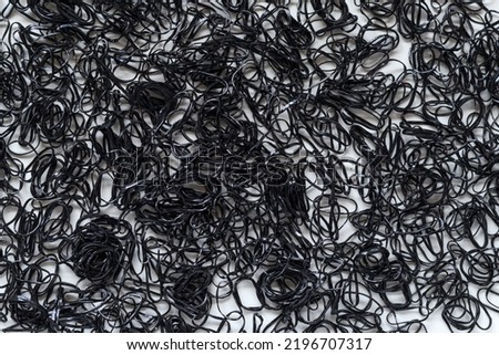 black rubber band background with lots of black on the floor is the perfect background for design and copy space for advertising text. Hair rubber band background with black and Copy Space for text
