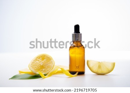 bottle essential oil with lemon isolated on white background.