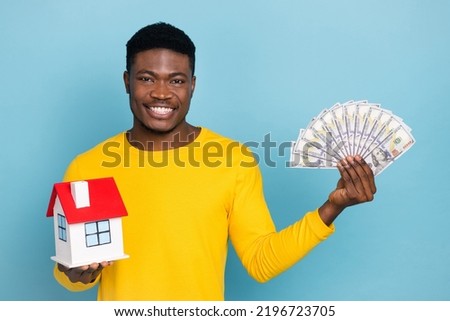 Photo of nice young brunet guy hold home home wear yellow shirt isolated on blue color background