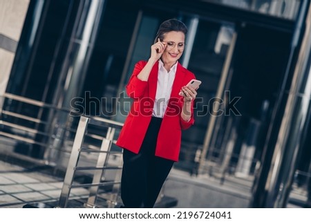 Photo of positive smart age lady employer representative read social network post career development outside office