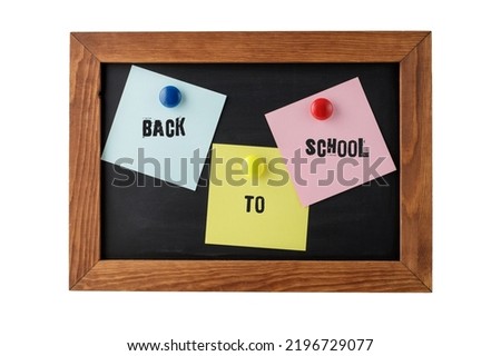 Colorful notepapers on magnetic blackboard with vintage text back to school isolated on white background. Black memo board with text