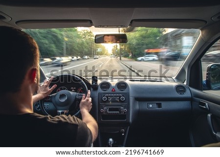 Hands on the wheel when driving at high speed from inside the car. Royalty-Free Stock Photo #2196741669