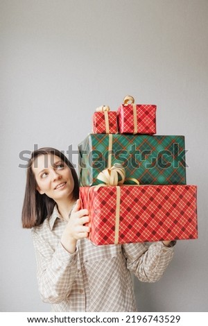 woman is holding boxes with gifts for Christmas, new year or birthday. Women's hands put give gifts. festive mood, seasonal sales in stores, time to shop for the holidays