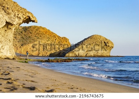 People walking on Monsul beach in Cabo de Gata Nijar Natural Park. Coast of Almeria. Huge lava formation as tourist attraction. Royalty-Free Stock Photo #2196743675