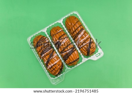 Fresh eclair cake, covered with boiled condensed milk and chocolate icing, in a package