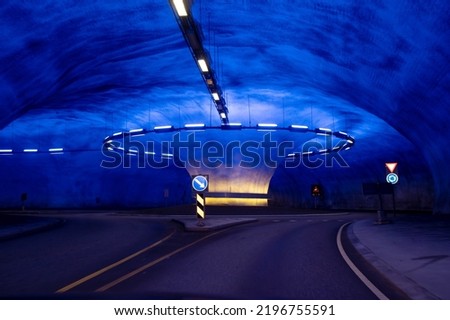 Roundabout in a tunnel in Norway, lighted in blue, beautiful architecture style