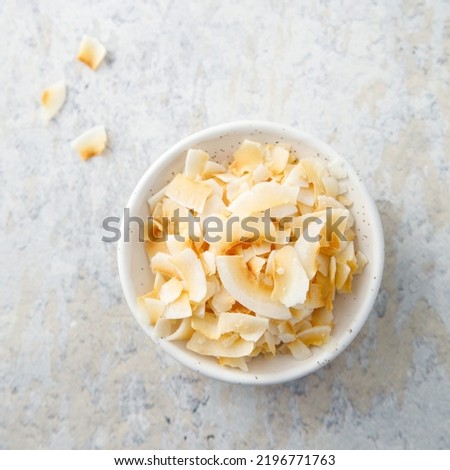 Organic homemade coconut chips in a bowl Royalty-Free Stock Photo #2196771763