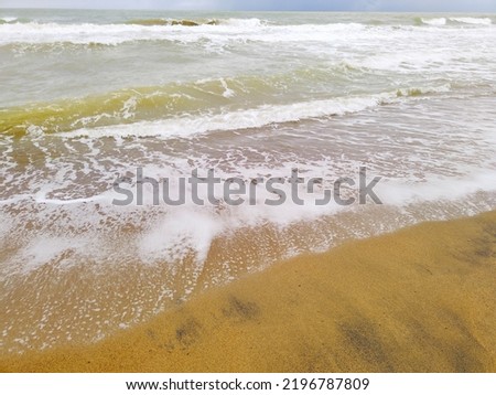 Soft wave of the sea on the clean sandy beach. blurry waves