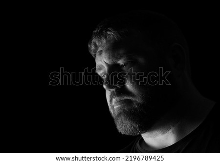 Adult Caucasian male looking upset with a tear running down his face.