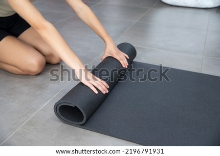 Hands unwind sports mat. Background with place for sports training schedule. Yoga mat. Space for text. Royalty-Free Stock Photo #2196791931