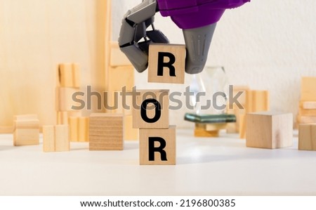 ROR the word on wooden cubes, cubes stand on a reflective surface, in the background is a business diagram. Business and finance concept. ror - short for rate of return