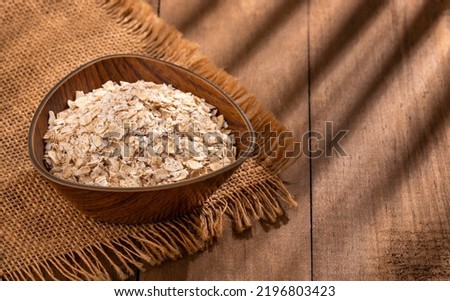 Oat flakes in the wooden bowl - Avena sativa