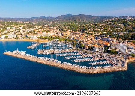 Summer aerial view of French coastal town of Sainte-Maxime on Mediterranean coast overlooking marina with moored pleasure yachts and residential houses on green hills Royalty-Free Stock Photo #2196807865