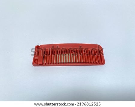 Red small travelling hair comb with mirror, isolated on white background