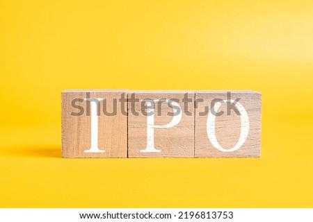 A technical term of IPO on wooden cubes on yellow background, Initial public offering, Finance or stock background, Economy