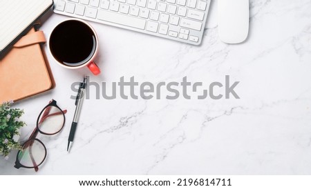 Top view, White Office desk with keyboard computer, cup of coffee, pen, eyeglass, mouse and notebook, copy space, Mock up...	

