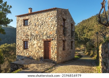Street and stone house in the village of Casal de São Simão, Portugal, lit by the sun in the late afternoon. Royalty-Free Stock Photo #2196816979