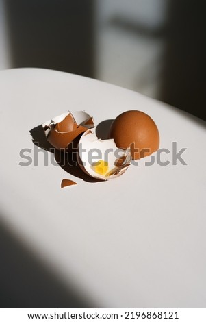 Vegetarianism and digital technologies. An egg shell on a light table with a symbolic pixelated yolk