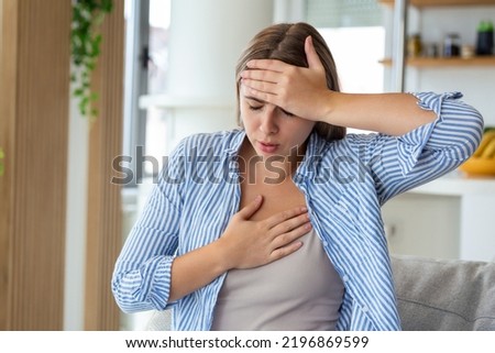 Breathing, respiratory problem, asthma attack, pressure, chest pain, sun stroke, dizziness concept. portrait of woman received heatstroke in hot summer weather, touching her forehead Royalty-Free Stock Photo #2196869599