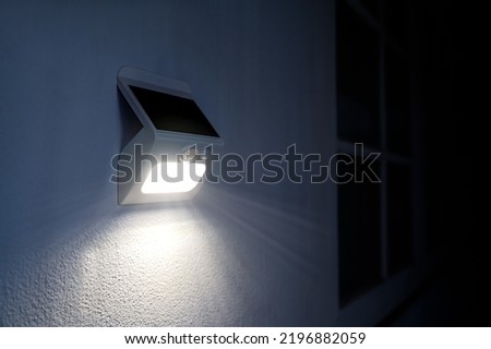 Small solar powered led light with motion sensor.	 Royalty-Free Stock Photo #2196882059