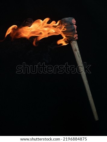 ancient wooden torch isolated on black background Royalty-Free Stock Photo #2196884875