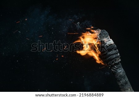 ancient wooden torch isolated on black background Royalty-Free Stock Photo #2196884889