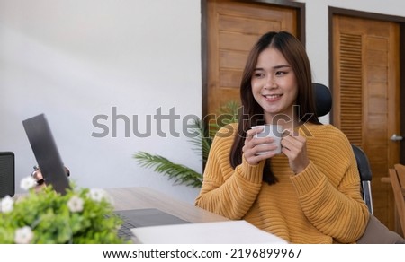 Profile side photo of smart chinese girl ceo expert sit desk work remote laptop texting typing report hold beverage mug in house indoors
