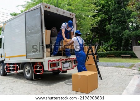Professional goods house move service use truck carry personal belongings door to door transport delivery handover boxes luggage one by one and keep on the floor before transfer to place in house
