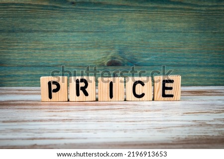 PRICE concept. Alphabet wooden blocks on green and white background.