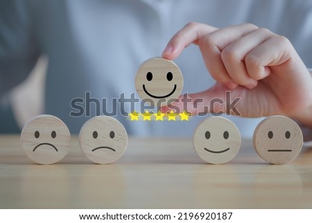 Feedback rating and positive service review. Customer experience, Mental health assessment, World mental health day, think positive, Emotion, satisfaction survey. Hand choosing happy face with 5 star. Royalty-Free Stock Photo #2196920187